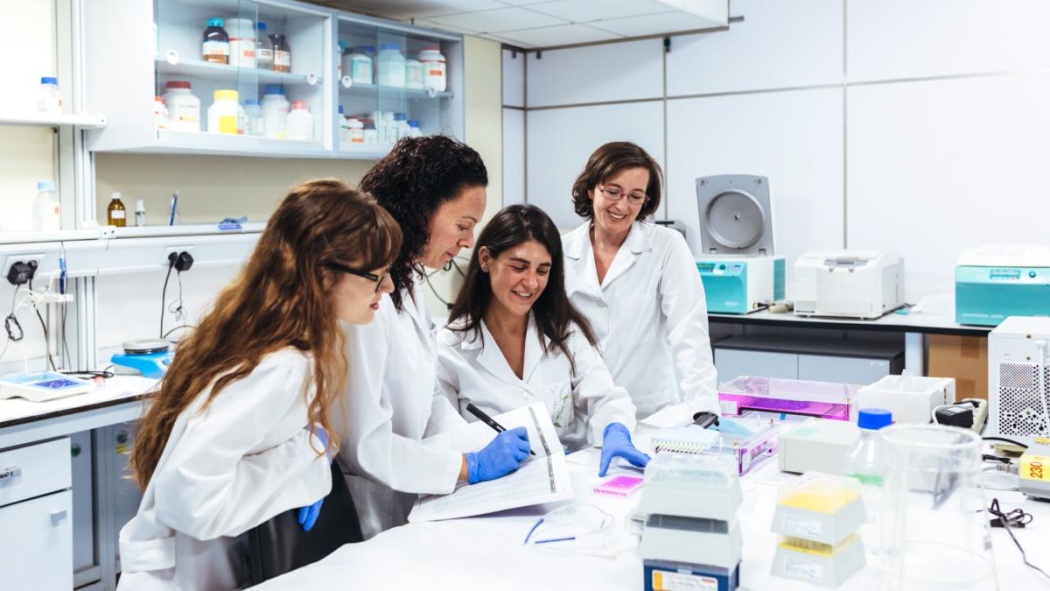 scientists smiling together in a lab