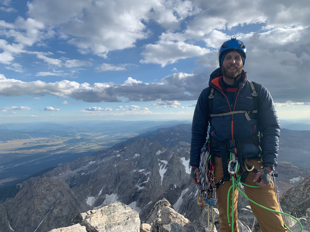 Sam Wright climbing a mountain
