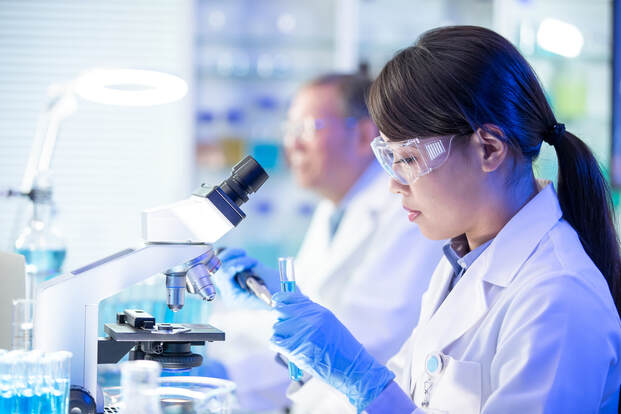 scientist with microscope