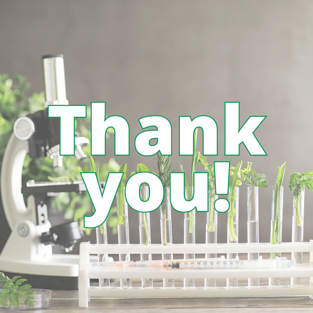 Thank you in white in front of microscope