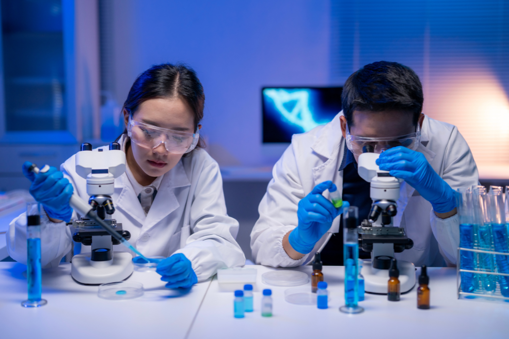 two scientists conducting research, microscope, test tubes