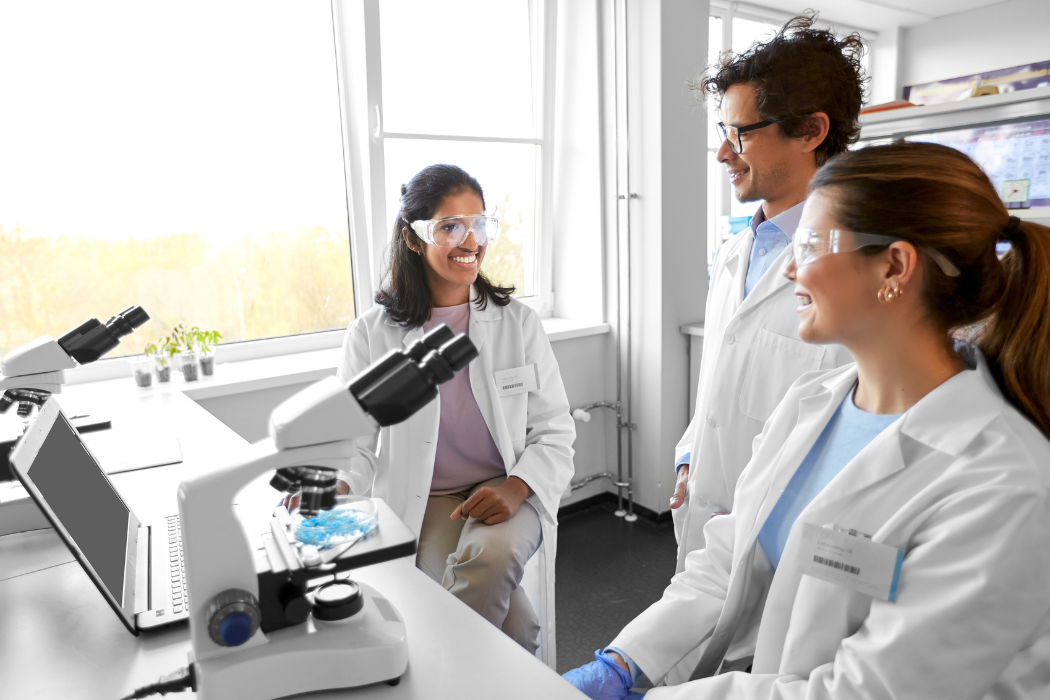 Three scientists collaborating on sustainability initiatives