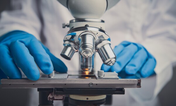 microscope and blue gloves